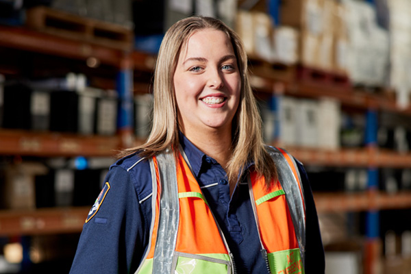 Photo of a female ESA staff in uniform with a high-vis jacket on.