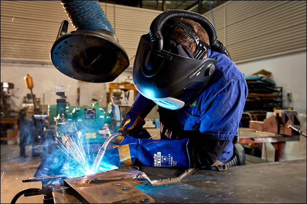 A workshop mechanic welding